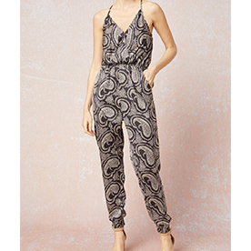 Paisley print satin surplice sleeveless jumpsuit featuring pockets at sides. Keyhole button closure at back. Elastic at waist and ankles with snap button closure at bust.