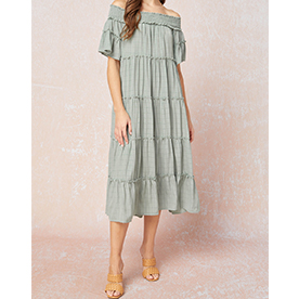 Solid textured off shoulder tiered midi dress featuring smocking detail at neckline and pockets at sides. Lined. 