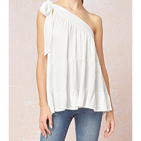 One shoulder white top with loose fit featuring self tie closure at shoulder. 