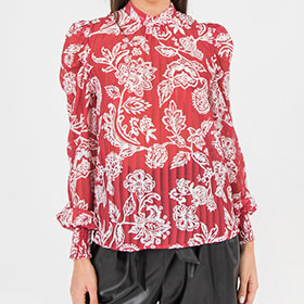 A printed shadow woven top featuring high neckline, puff sleeves, smocked cuffs and back keyhole button closure.