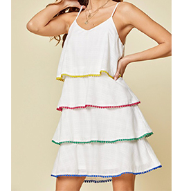 Beautiful white short dress with adjustable straps, featuring ruffles with a small colorful detail of pom poms on each ruffle. Fully Lined. 